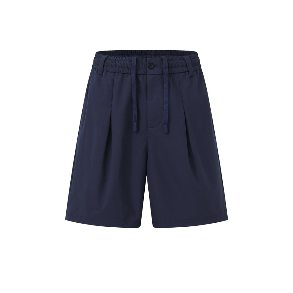 Navy pleated drawstring shorts with elastic waistband and button, flat front view on white background