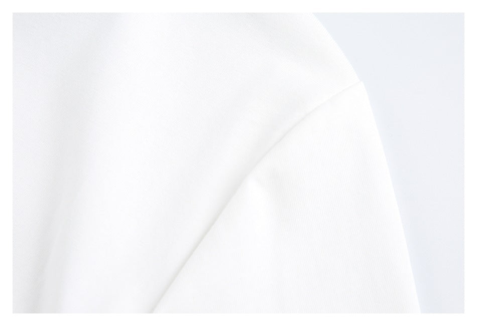 Close-up of a white shirt's shoulder and sleeve seam.