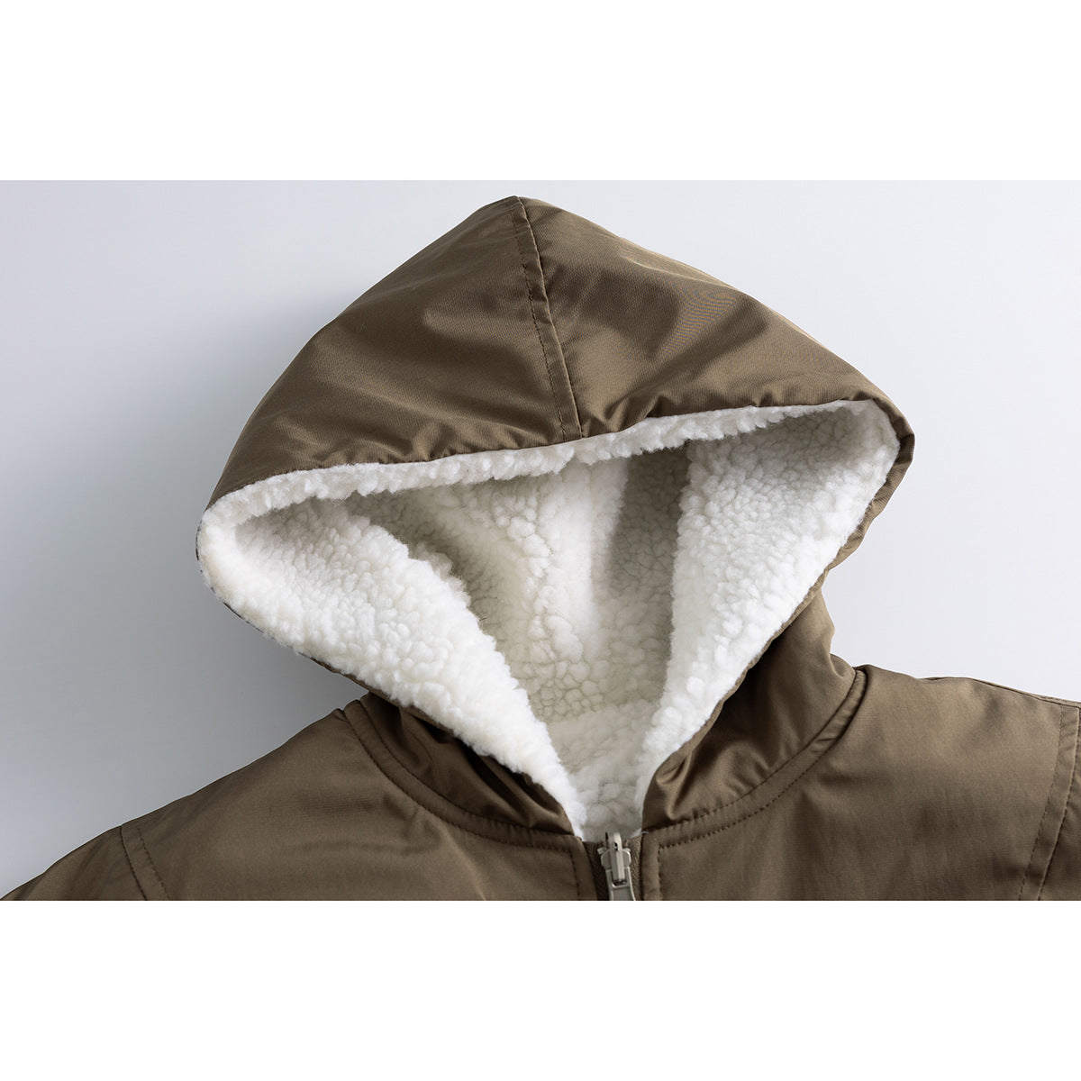 Close-up of an olive-brown jacket hood with thick white fleece lining and a front zipper.