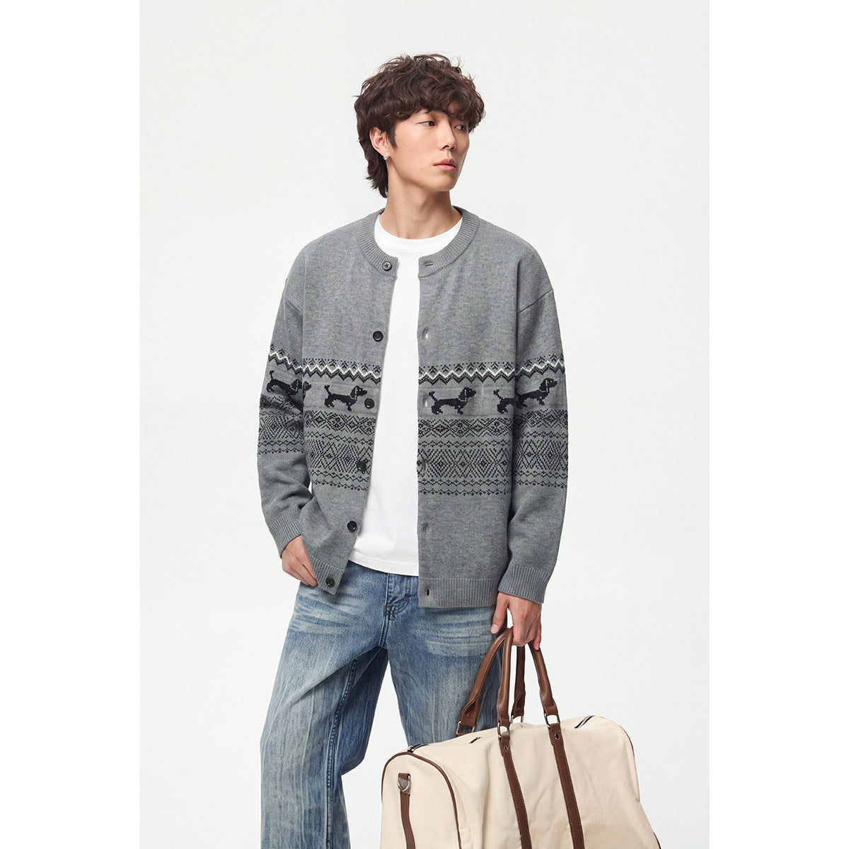 Closer view of a model in a gray cardigan with black dog motifs and geometric bands across the front and sleeves.