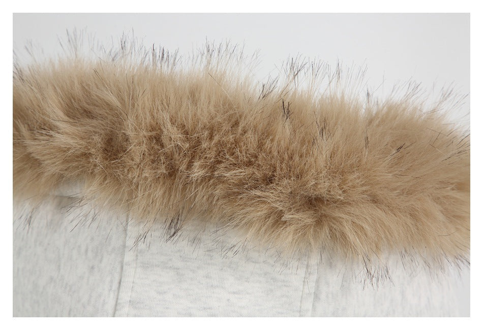 Close-up of fluffy tan faux-fur trim attached to pale gray fabric.