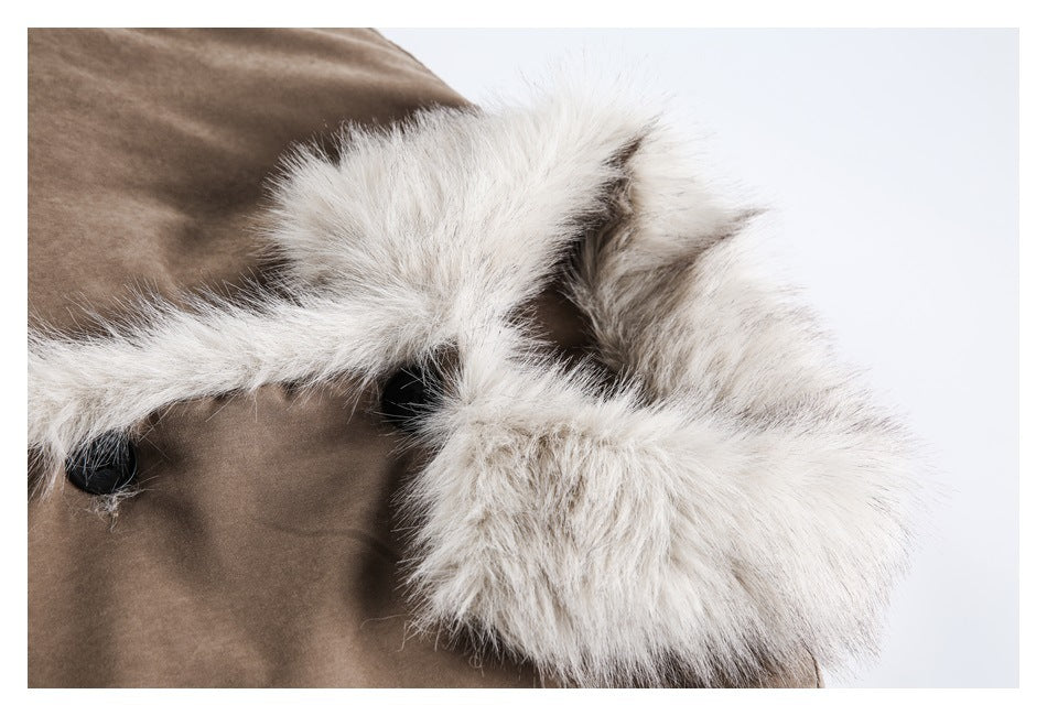 Close-up of cream fur trim around the hood of a taupe coat.