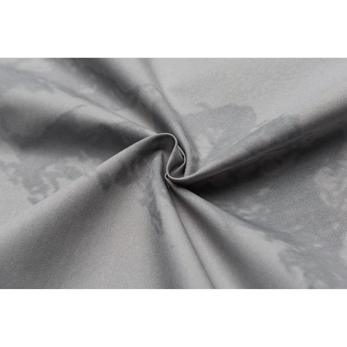 Close-up of gray fabric with a subtle cloudy pattern, gathered into a central twist.