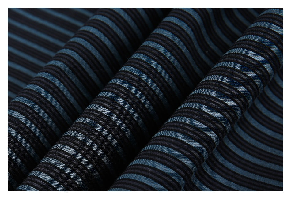 Close-up of dark blue-and-black striped fabric folded into soft ridges.
