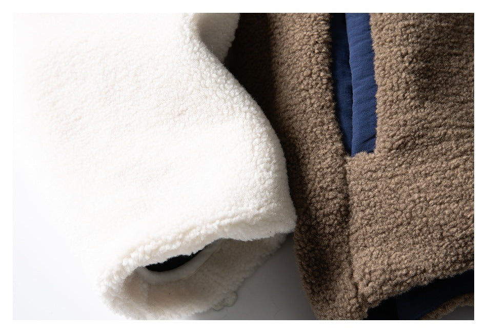 Close-up of white and brown textured fleece with a narrow navy trim.