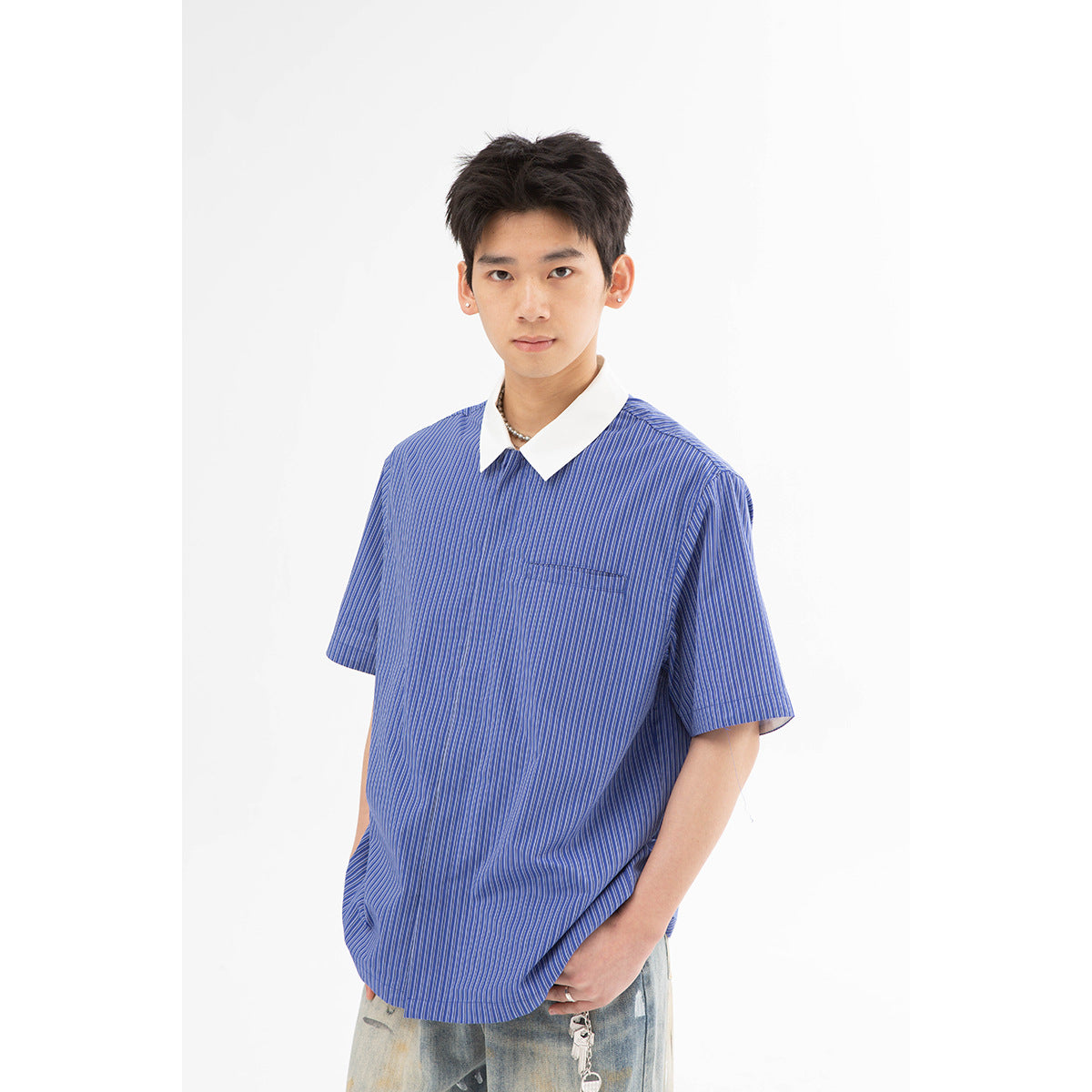 Front view of a model in a blue pinstriped short-sleeve shirt with a white pointed collar and chest pocket.