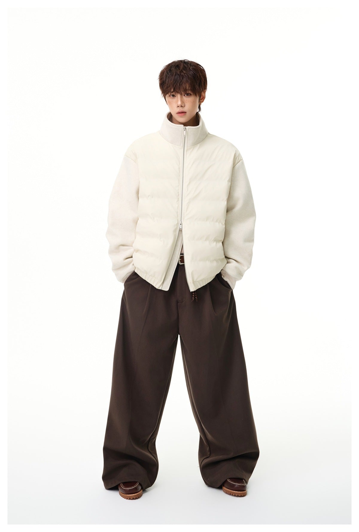 Model wearing an ivory hybrid jacket with a quilted front, textured sleeves, and a high stand collar.