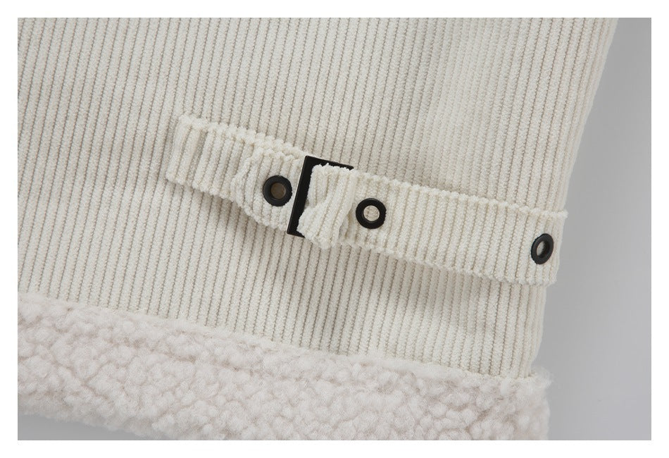 Close-up of a cream corduroy jacket's adjustable snap-tab belt above its fluffy sherpa trim.