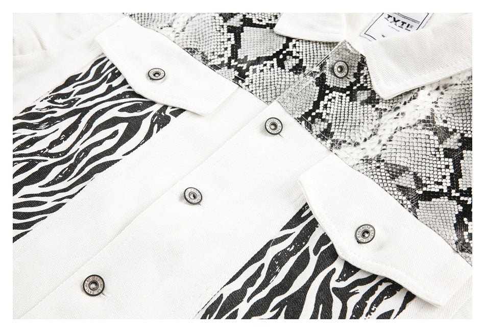 Close-up of overlapping white and black jacket fronts with snaps, zebra stripes, and snakeskin-print panels.