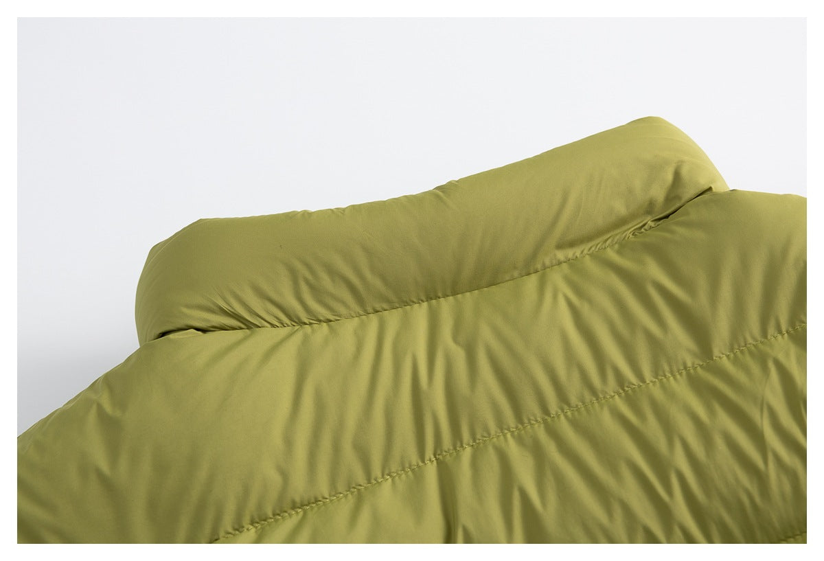 Close-up of the olive-green padded garment's smooth raised edge and diagonal quilting seam.
