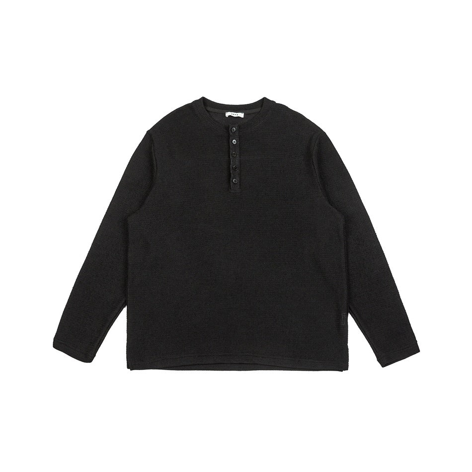 Black long-sleeve textured knit henley top with button placket, flat front view