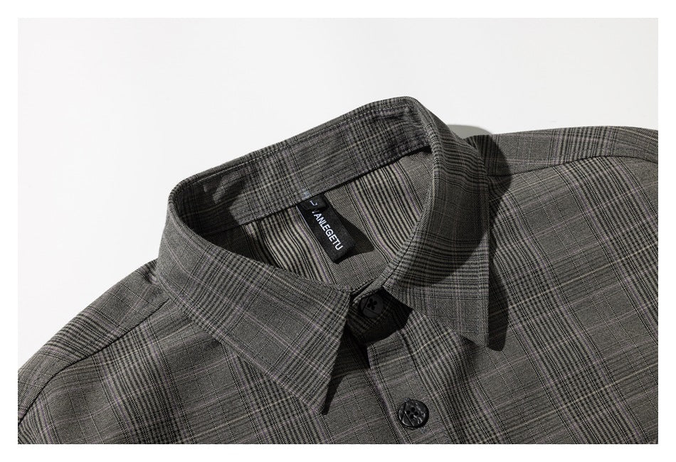 Close-up of the gray plaid shirt collar, buttons, and sewn-in neck label.