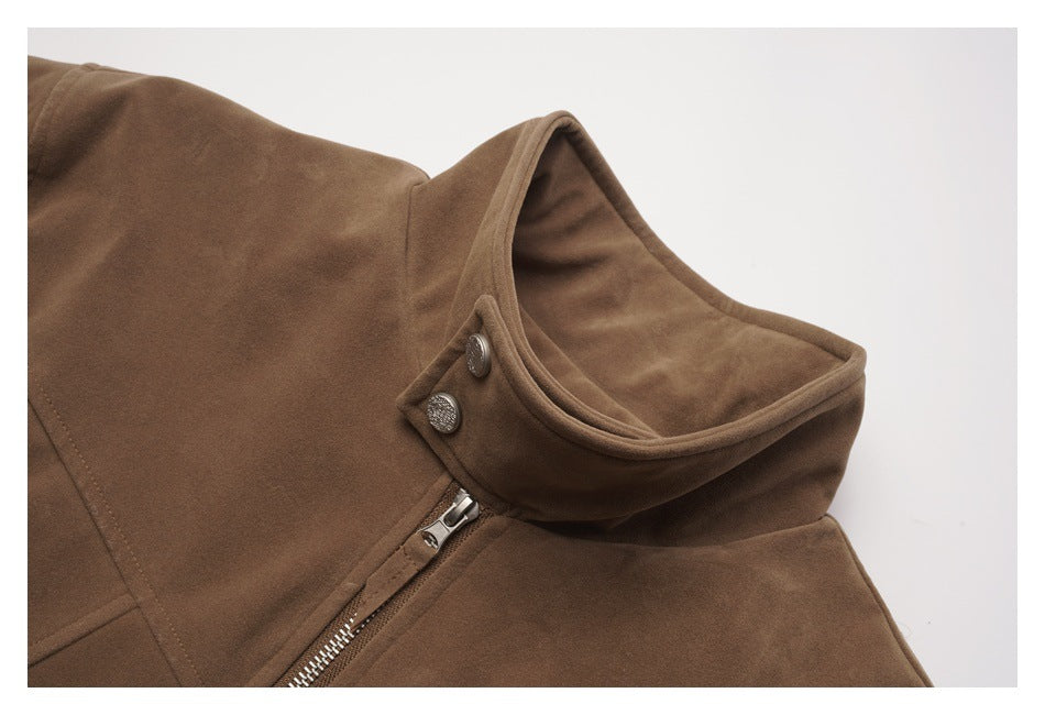 Close-up of a brown jacket’s stand collar with two metal snaps and a diagonal silver zipper.