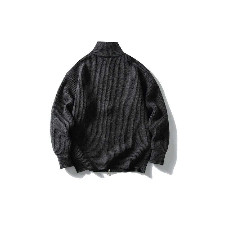 Back view of a black rib-knit cardigan with a high collar and long sleeves.
