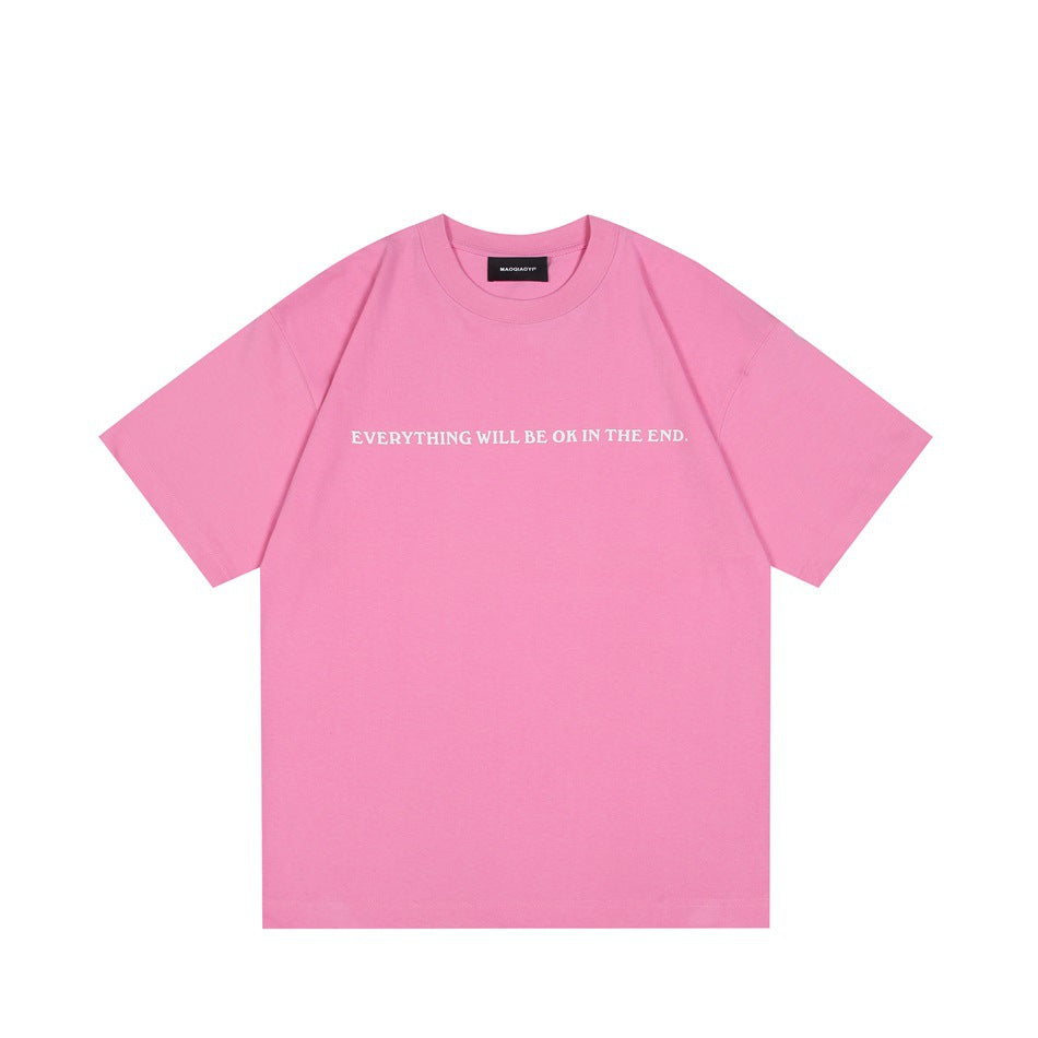 Pink short-sleeve crew-neck T-shirt with white slogan text across the chest, flat front view