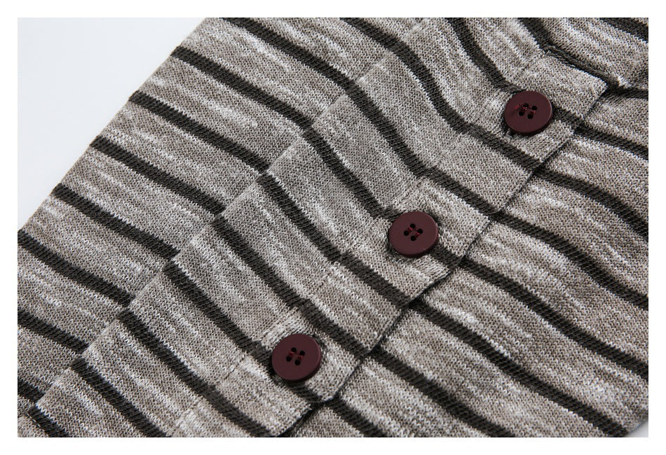 Close-up of the button placket and three burgundy buttons on a gray and black striped knit garment.