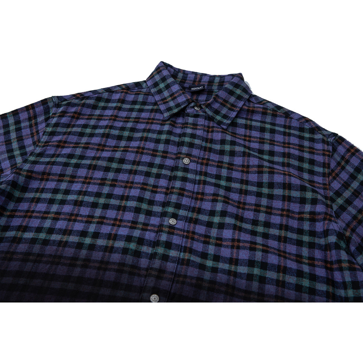 Close view of a purple, teal, and black plaid button-up shirt front with a pointed collar.