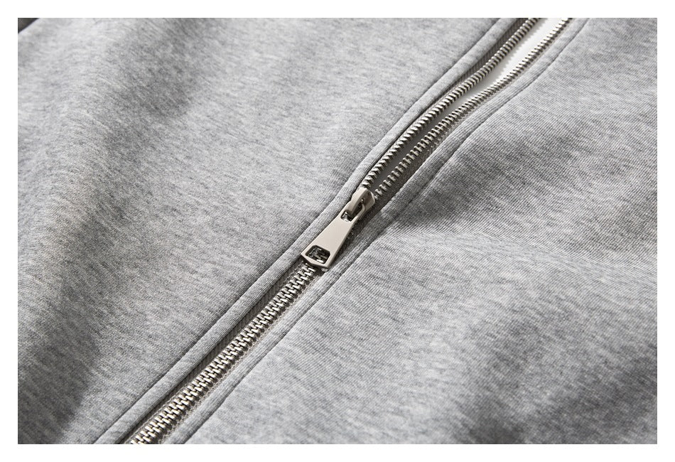 Close-up of the heather gray jacket's silver front zipper and pull.