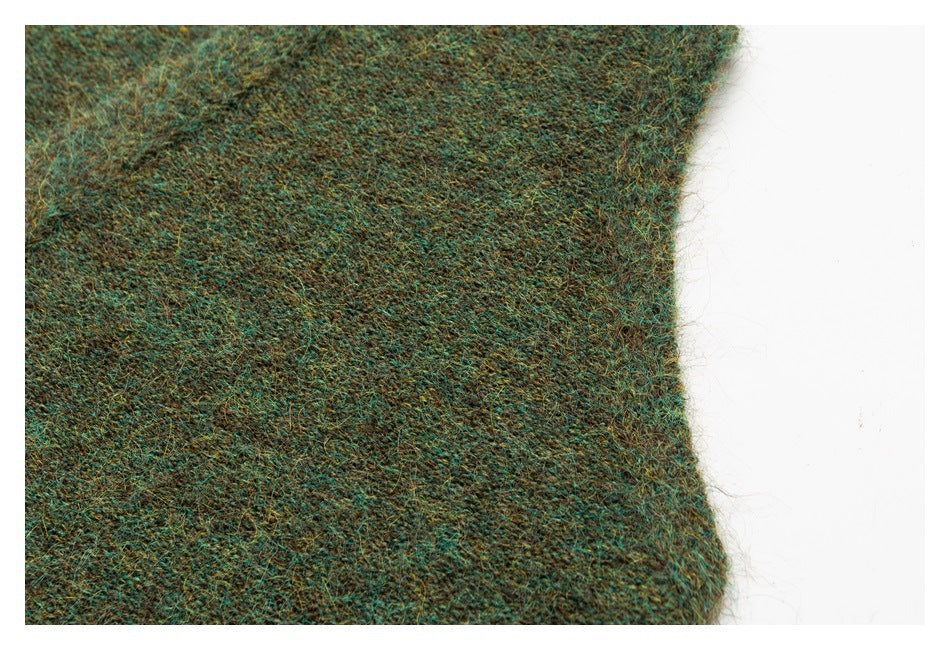 Close-up of the edge and fuzzy texture of a mottled teal-brown knit garment.