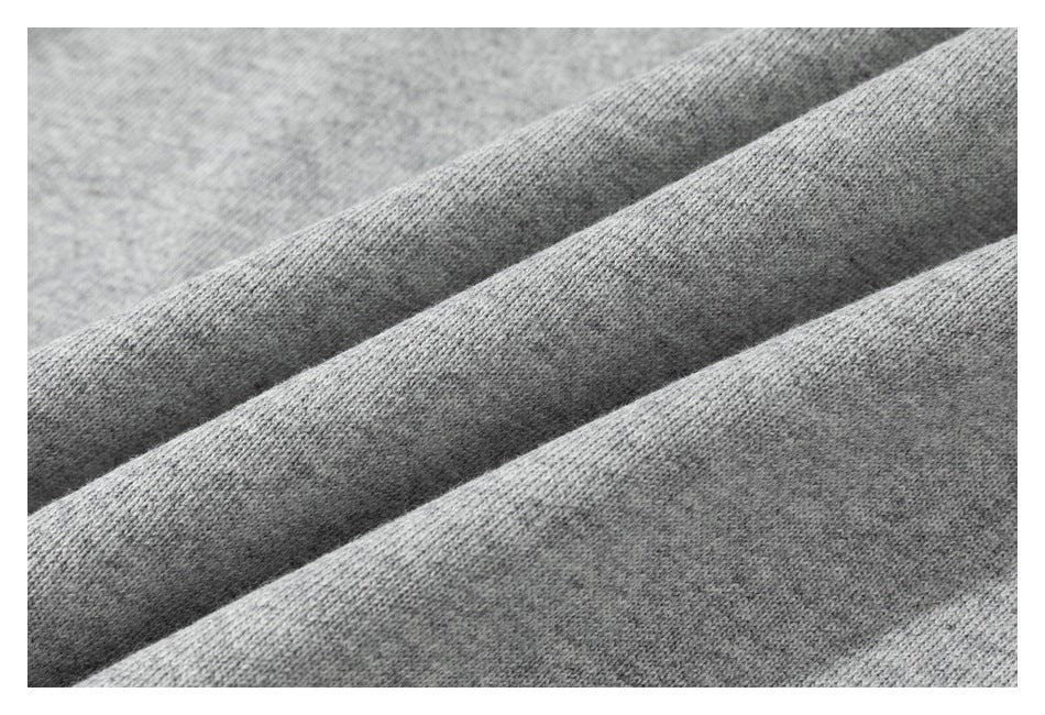 Close-up of gray knit fabric showing its soft, fine-textured surface.