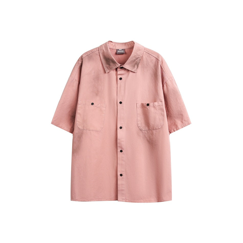 Dirty pink short-sleeve button-up shirt with two flap chest pockets and a sprayed gray distressed effect, front view