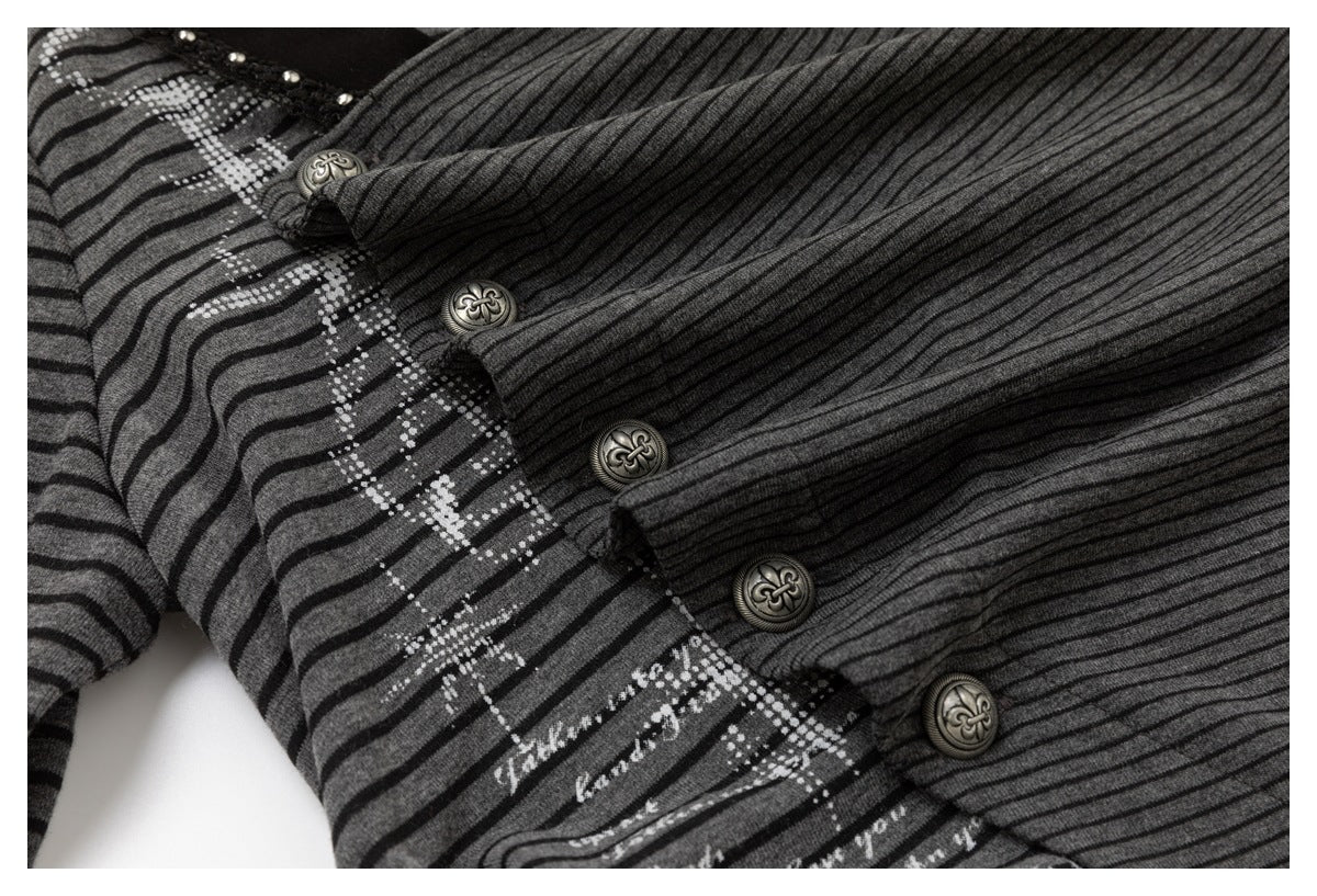 Close-up of a charcoal striped top with a patterned panel and ornate buttons along the front.