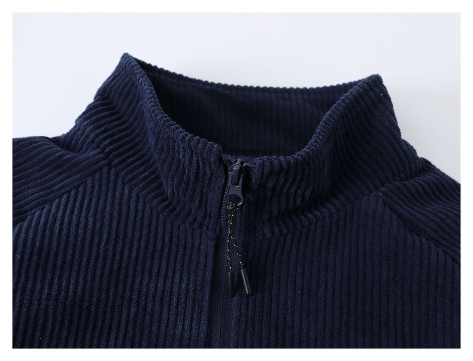 Close-up of the navy ribbed jacket's raised collar and front zipper.