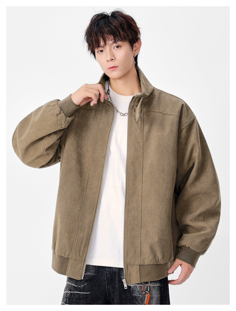 Model wearing a taupe zip-front jacket with a stand collar, oversized sleeves, and ribbed cuffs and hem.