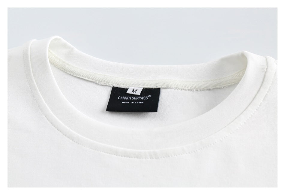 Close-up of the white top's crewneck collar, stitching, and neck label.