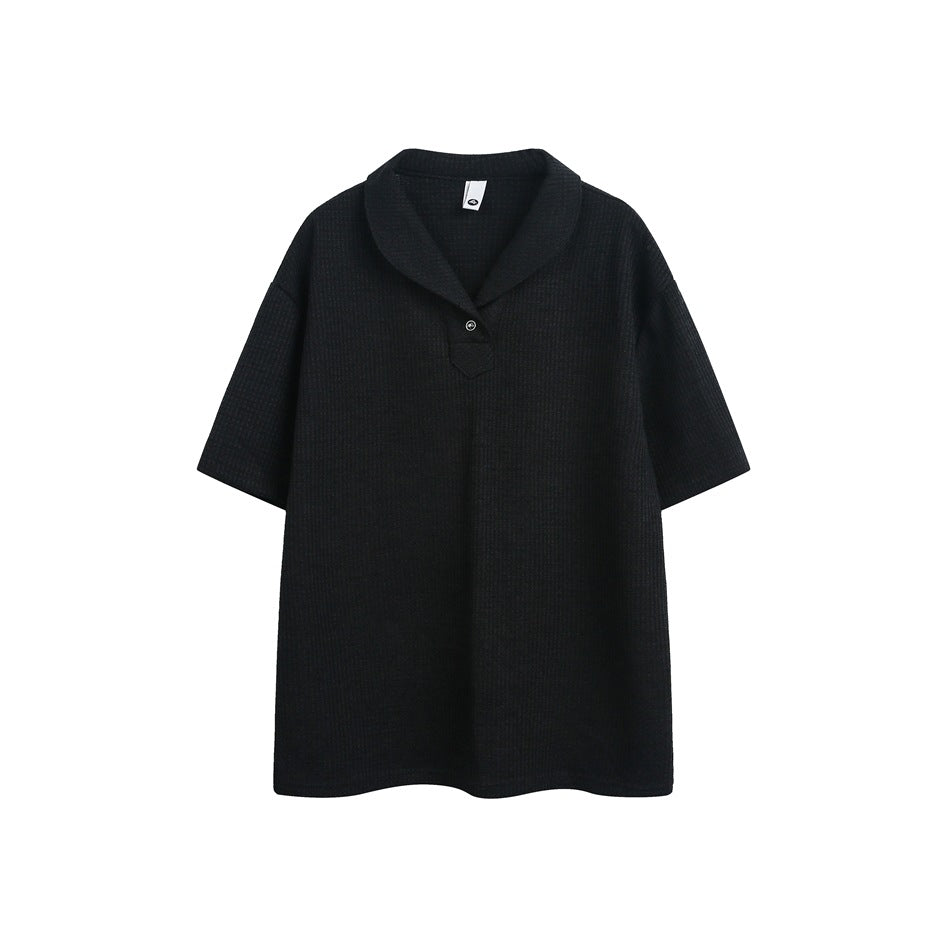 Black waffle-knit short-sleeve polo top with shawl collar and single button, flat front view
