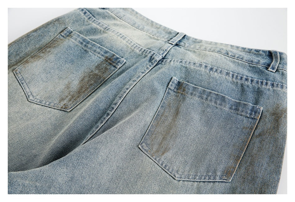 Back view of light blue faded jeans showing two patch pockets and belt loops.