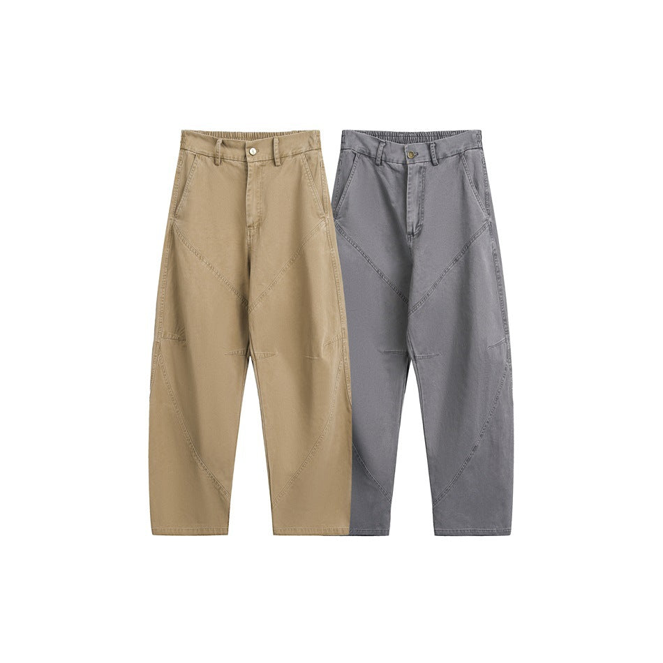 Front view of two pairs of loose, wide-leg trousers in tan and charcoal, displayed side by side.