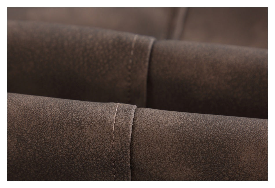 Close-up of stitching and seams on mottled brown jacket panels.