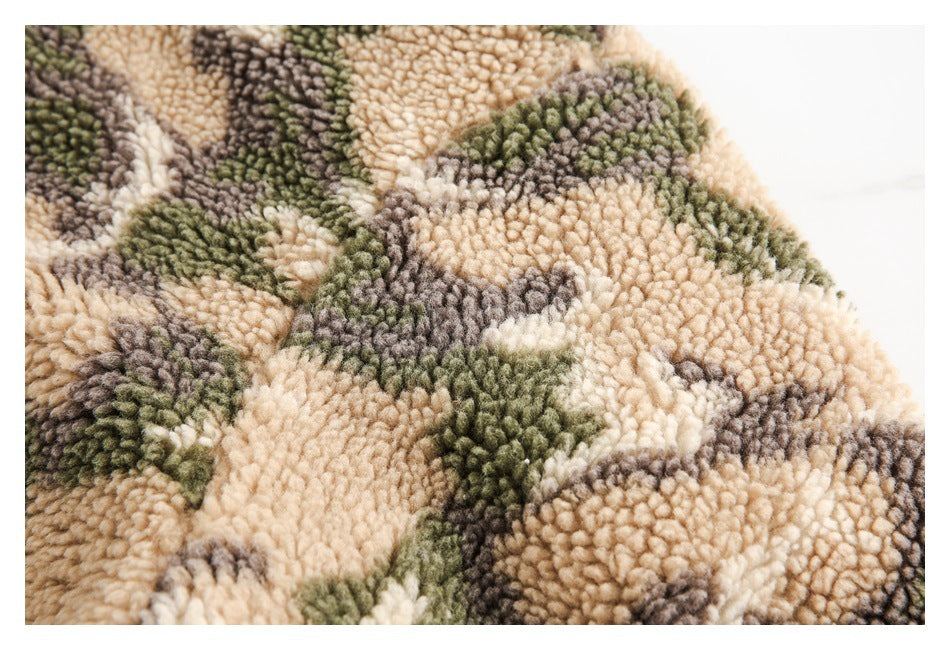 Close-up of plush fleece with a mottled beige, olive green, and gray camouflage pattern.