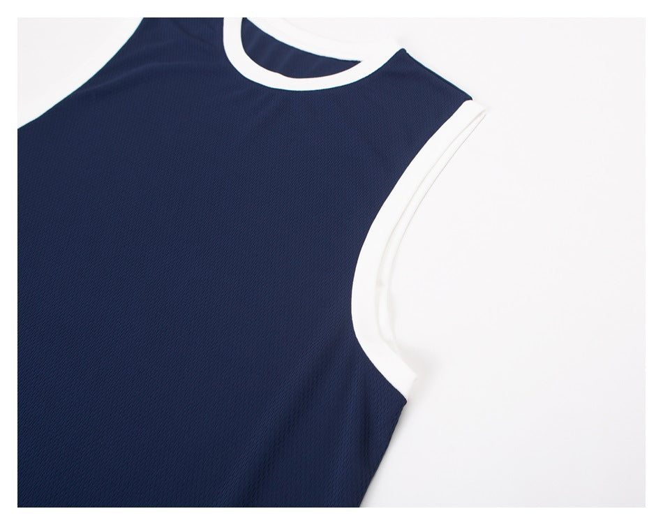 Close-up of a navy sleeveless top showing its white-trimmed crew neck and armhole.