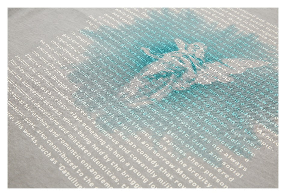 Close-up of overlapping white and teal English text printed on gray fabric.
