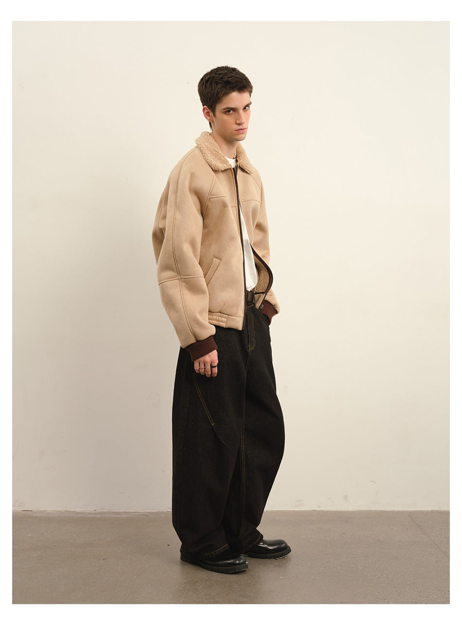 Three-quarter view of a model wearing a beige zip jacket with a plush collar and wide-leg black trousers.