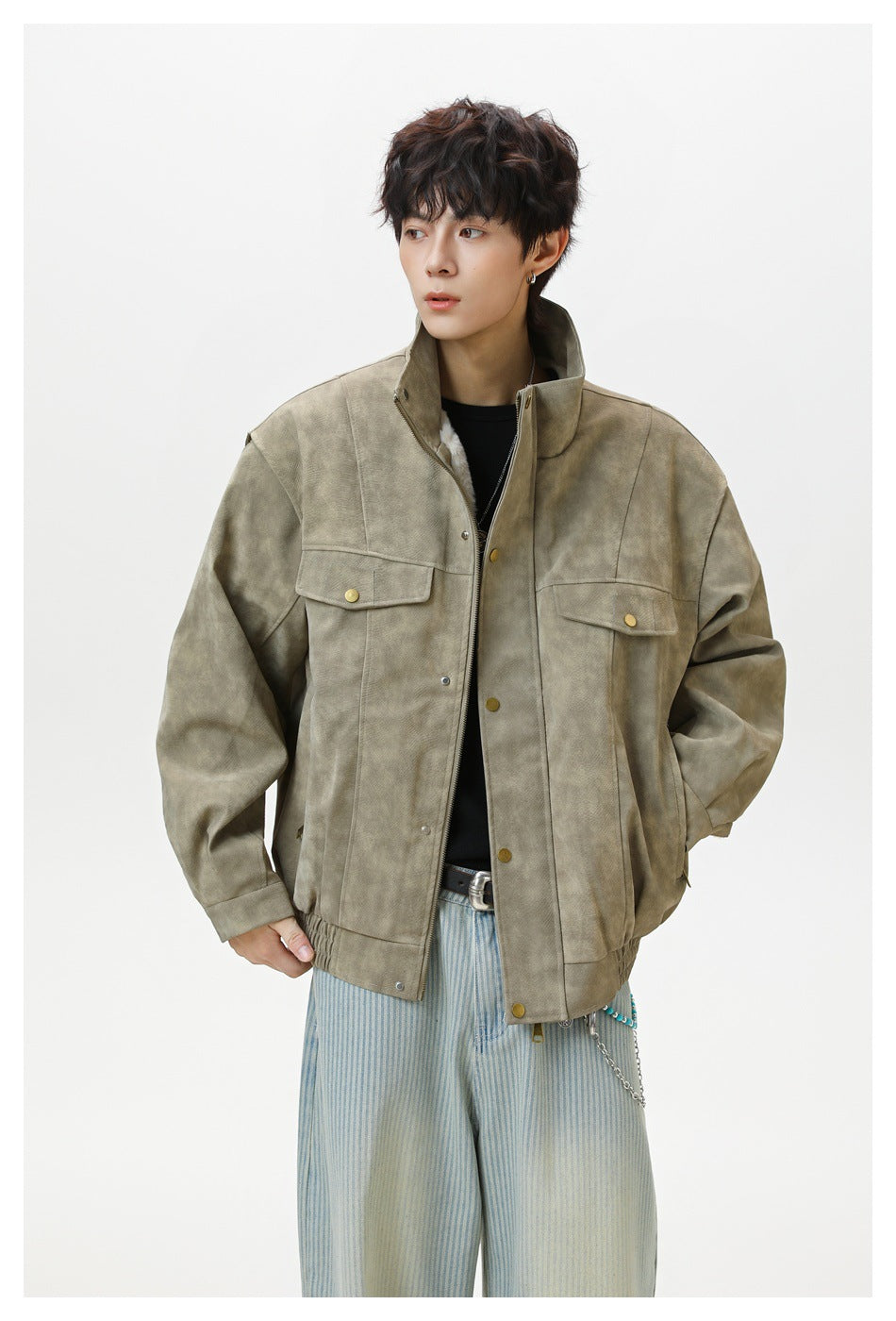 Front view of a model wearing a taupe mottled jacket with a stand collar, flap chest pockets, and brass-tone buttons.