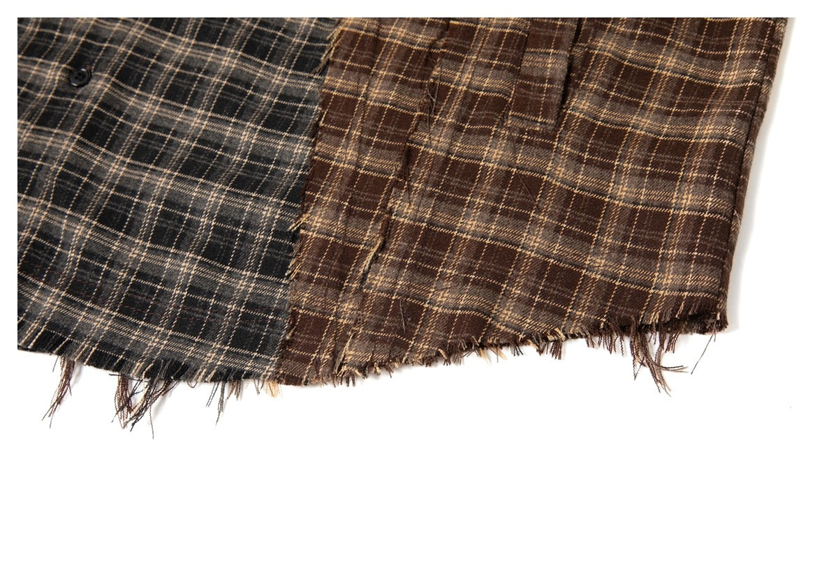 Close-up of charcoal and brown plaid shirt hems with frayed edges on a white background.