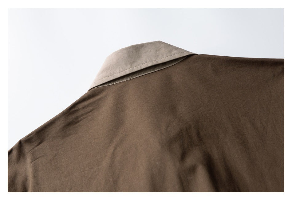 Close-up of the back shoulder and light beige collar on a brown garment.
