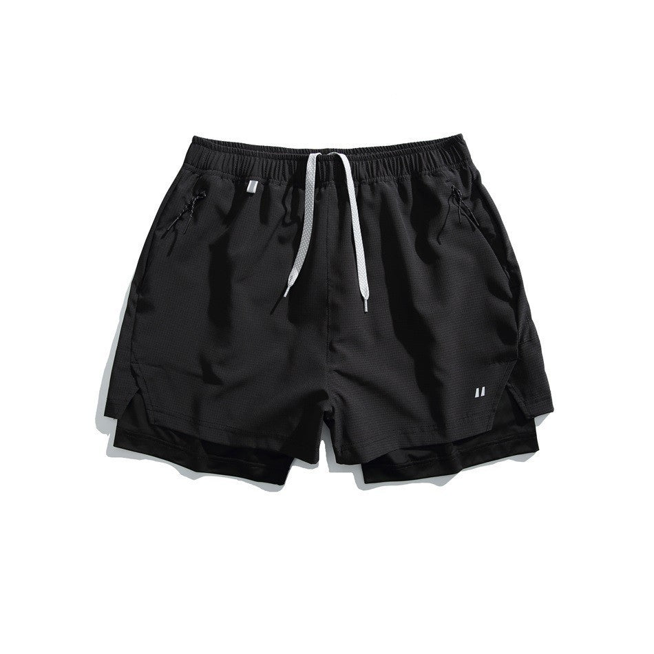 Black double-layer athletic shorts with white drawcord, zip pockets and black inner layer, flat lay front view