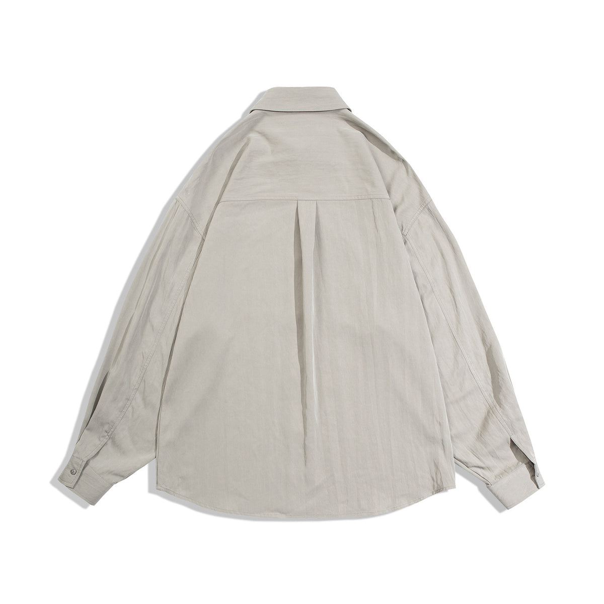 Back view of a light beige oversized long-sleeve button-up shirt with a yoke and center pleat.