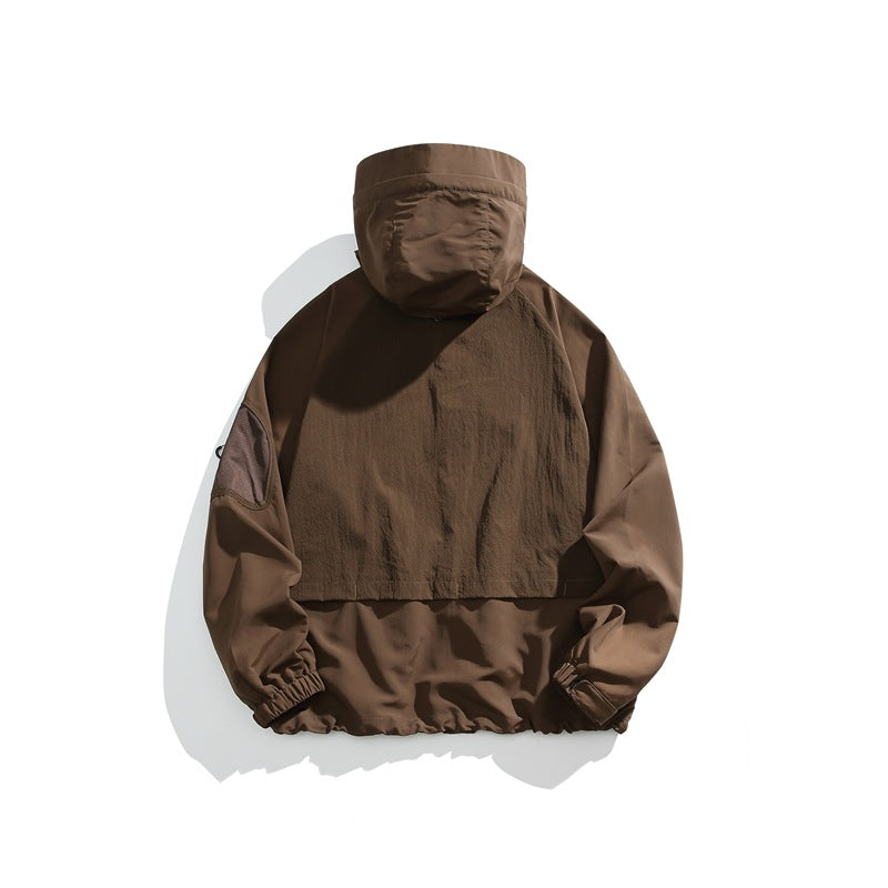 Back view of a brown hooded jacket with a large rear panel and elastic cuffs and hem.