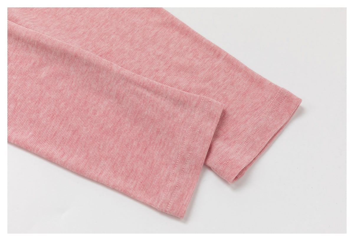 Close-up of overlapping heather-pink sleeve edges with finished hems.