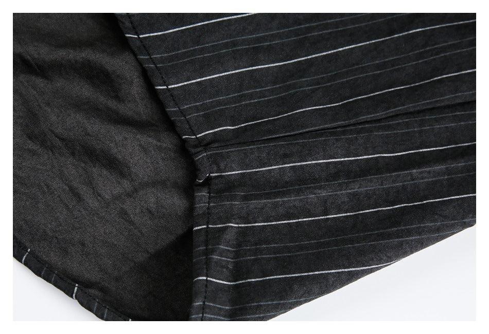 Close-up of the black pinstriped shirt's inside fabric and hem seam.