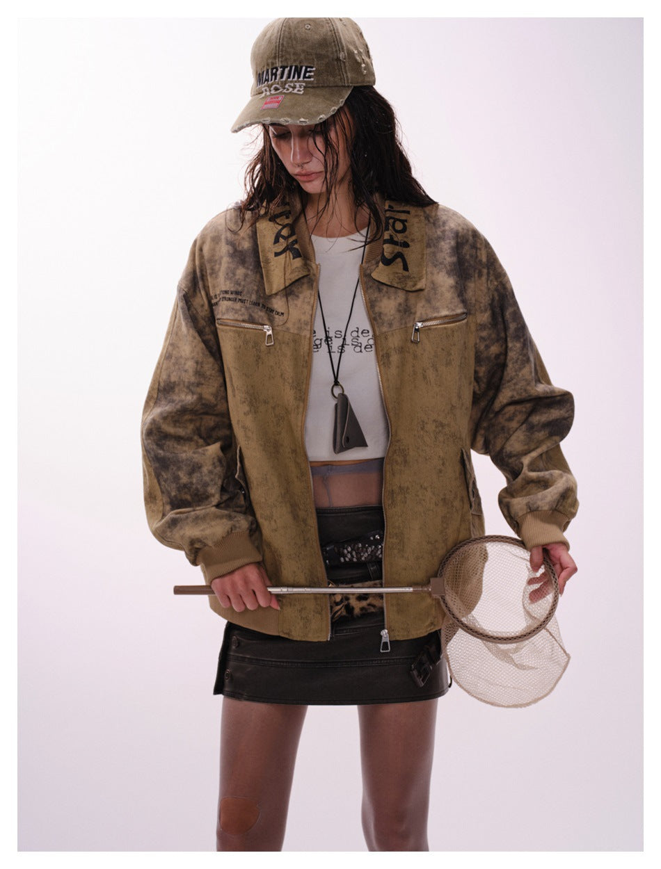 Model wearing an open mottled tan-brown jacket with darker sleeves, two chest zip pockets and ribbed cuffs.