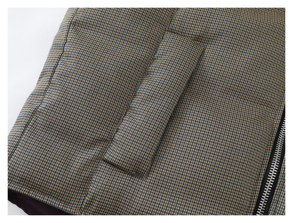 Close-up of a rectangular pocket and silver zipper on the patterned jacket.