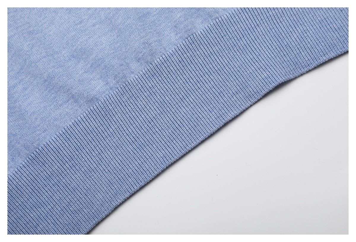 Close-up of the light blue knit garment's wide ribbed hem.