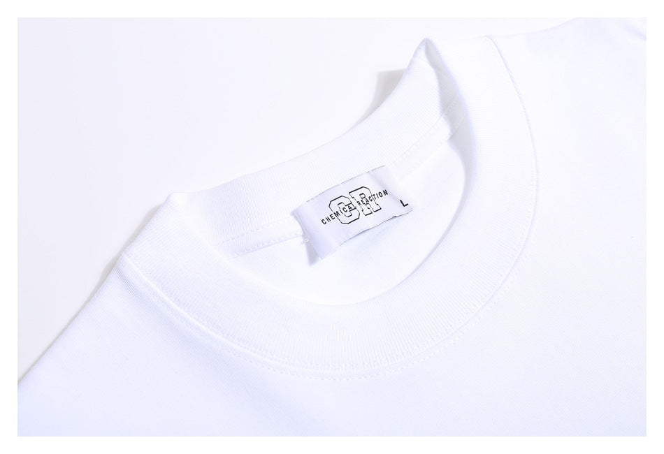 Close-up of a white T-shirt's ribbed crew neckline and sewn-in Chemical Reaction size L label.