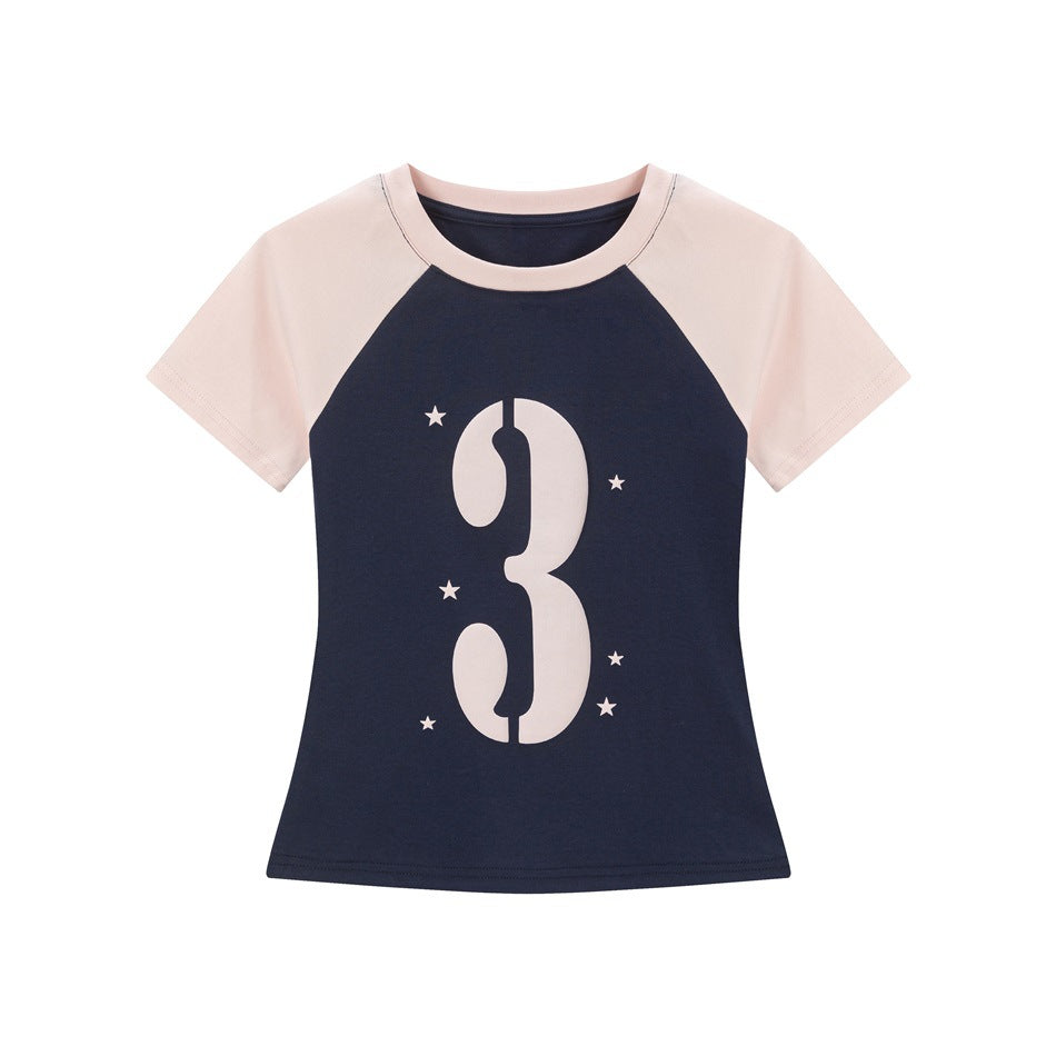 Navy raglan T-shirt with light pink sleeves and collar, large pink stencil number 3 graphic and stars, flat lay